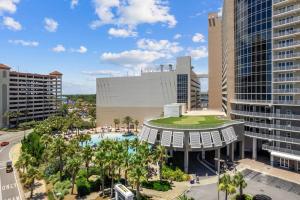 an aerial view of a resort with a pool and palm trees at Beautiful Panama City Beach Condo- Ocean View! in Panama City Beach