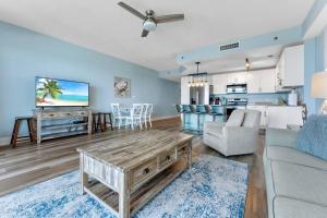 a living room with a couch and a table at Beautiful Panama City Beach Condo- Ocean View! in Panama City Beach