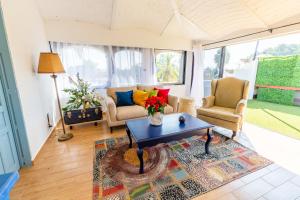 a living room with a table and two chairs at Plaza Chapala Hotel in Chapala