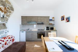 a kitchen with a table and a counter top at Apartments Zeljko in Kampor +54 photos