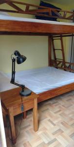 a desk with a lamp next to a bunk bed at Hondelz Budget Homestay in Busuanga