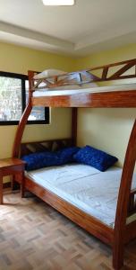 a bedroom with two bunk beds in a room at Hondelz Budget Homestay in Busuanga