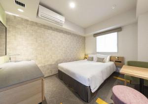 a hotel room with two beds and a sink at Tokyu Stay Sapporo Odori in Sapporo