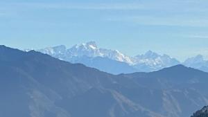 a view of a mountain range with snow capped mountains at Ananta Prana in Mussoorie