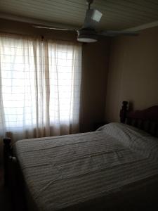 a bedroom with a bed in front of a window at El refugio in San Antonio de Areco