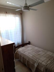 a bedroom with a bed and a ceiling fan at El refugio in San Antonio de Areco