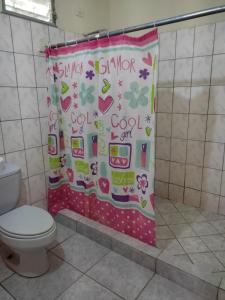 a shower curtain in a bathroom with a toilet at Cabañas El Valle in Antón