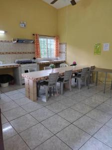 a kitchen with a table and chairs in a room at Cabañas El Valle in Antón
