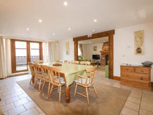 a dining room with a table and chairs at Hadleigh Farm Barn in Gayton
