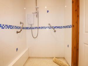 a bathroom with a shower and a bath tub at Hadleigh Farm Barn in Gayton +35 photos