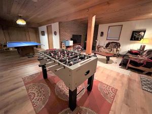 a ping pong table in the middle of a living room at Lakefront Cabin Pvt Beach and Dock - Sunset Marina in Arrowhead Lake