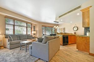 a living room with two couches and a kitchen at Sundial Lodge by Park City - Canyons Village in Park City