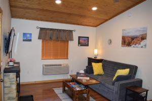 a living room with a couch and a table at Log Cottages at Bryce Canyon #3 in Cannonville