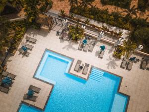 an overhead view of two swimming pools in a hotel at H&ocirc;tel Bambou & Spa in Les Trois-&Icirc;lets
