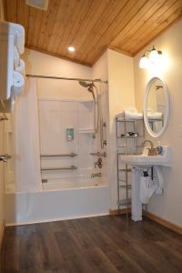 a bathroom with a shower and a sink at Log Cottages at Bryce Canyon #3 in Cannonville