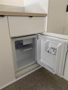 a small refrigerator with its door open in a kitchen at Toronto Hotel in Toronto