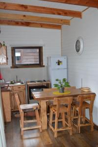 a kitchen with a table and chairs and a refrigerator at Ruca del Fuy in Panguipulli