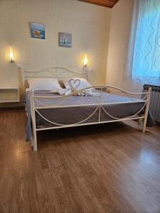 a large bed in a room with a wooden floor at Villa Karla in Jadranovo