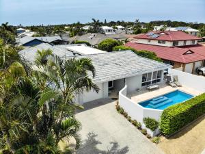 an aerial view of a house with a swimming pool at Bokarina Seaside Escape - Only steps to the Beach in Kawana Waters