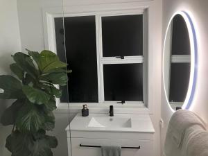 a bathroom with a sink and a window at Townhouse on Courtenay in New Plymouth +15 photos