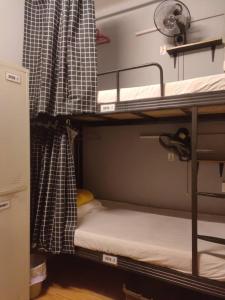 a room with two bunk beds in a dorm room at Cozy Private Bunk Bed Room in Bayan Lepas
