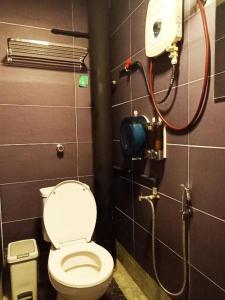 a bathroom with a toilet and a shower at Cozy Private Bunk Bed Room in Bayan Lepas
