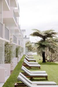 a row of chaise lounges on the side of a building at Bannisters Port Stephens in Soldiers Point