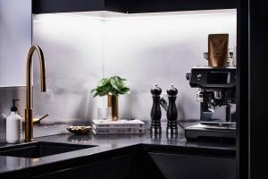 a kitchen with a sink and a coffee machine on a counter at Ruby by Whiskey June in Maryborough