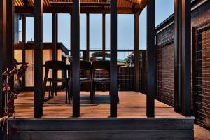 a wooden deck with a table and chairs on a building at Ruby by Whiskey June in Maryborough