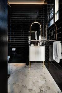 a black bathroom with a sink and a mirror at Ruby by Whiskey June in Maryborough +10 photos