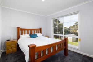 a bedroom with a bed and a large window at 9 Tunbridge Street in Rhyll