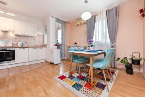 a kitchen and dining room with a table and chairs at Apartment Deluxe in Rovinj