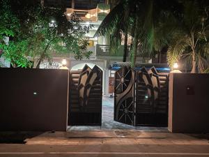 a pair of gates in front of a house at night at Catray Inn in Kalmunai