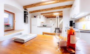 a bottle of wine sitting on a table with a wine glass at Apartment VILLA IRENA Great For a Family Holiday With Free Parking And EV Station in Ajdovščina +57 photos