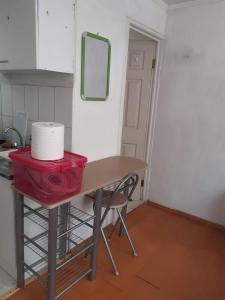 a table with a roll of toilet paper on it in a kitchen at Historia y comodidad in Valparaíso