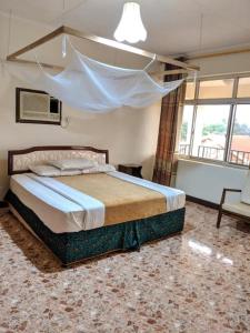 1 dormitorio con 1 cama grande en una habitación en Kilimanjaro Star Hotel en Moshi