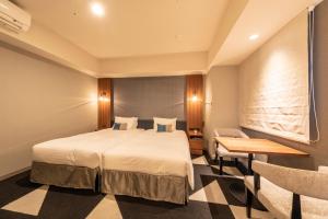 a hotel room with a bed and a desk at Tokyu Stay Sapporo Odori in Sapporo