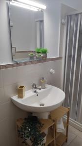 a bathroom with a white sink and a mirror at Amici di Laura in Messina