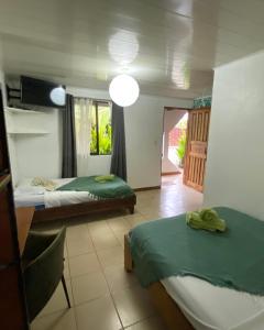 Ένα ή περισσότερα κρεβάτια σε δωμάτιο στο Cabinas Cahuita