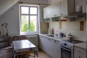 a kitchen with a sink and a table in a room at Domek na Wzgórzu in Cieszyn