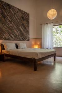 a large bed in a room with a window at La Closerie - Bay of Bengal in Puducherry