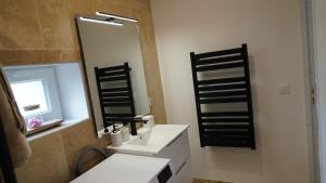 a bathroom with a white sink and a mirror at Le mas des glycines in Salon-de-Provence