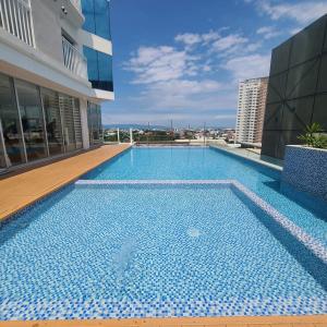 a swimming pool on the roof of a building at Inspiria Abreeza Davao in Davao City