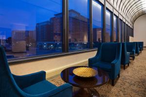 a waiting room with chairs and a table and a window at The Westin Crystal City Reagan National Airport in Arlington