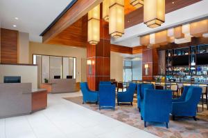 a hotel lobby with blue chairs and a bar at The Westin Crystal City Reagan National Airport in Arlington
