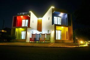 a house with two benches in front of it at night at Cozy House & Tour in Jeju