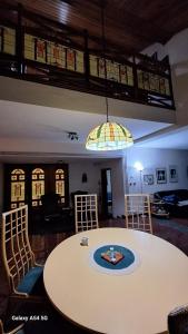 a living room with a table and a stained glass ceiling at vila zelenac in Požega