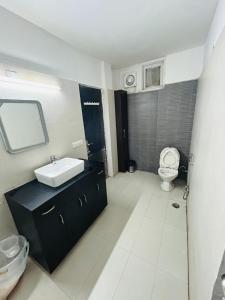 a bathroom with a sink and a toilet at Luxury Home Stay - Lajpat Nagar in New Delhi