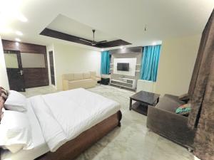 a bedroom with a bed and a living room at Luxury Home Stay - Lajpat Nagar in New Delhi +16 photos