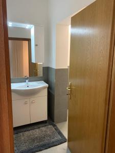 a bathroom with a sink and a mirror at Appartamento La Torre in Predazzo